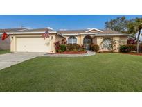 Cute one-story home with a landscaped yard and attached garage at 4135 Dover E Dr, Bradenton, FL 34203