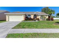 Single-story house with a two-car garage and well-manicured lawn at 4135 Dover E Dr, Bradenton, FL 34203