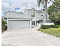 Charming gray two-story home featuring an attached two-car garage and well-manicured landscaping at 5132 36Th W St, Bradenton, FL 34210