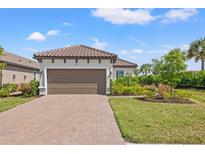 Single-story home with brown garage door and landscaped front yard at 3121 Tolmino Ct, Bradenton, FL 34211