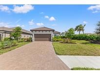 Single-story home with a paved driveway and landscaped front yard at 3121 Tolmino Ct, Bradenton, FL 34211