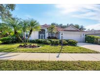 Attractive single-story home with landscaped yard and palm trees at 455 Park Trace Blvd, Osprey, FL 34229