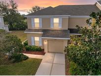 Charming two-story home with a well-manicured lawn, welcoming curb appeal, and an attached garage at 14847 Skip Jack Loop, Lakewood Ranch, FL 34202