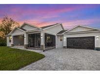 Modern single story home with screened porch and paver driveway at 2129 Lorraine Dr, Port Charlotte, FL 33953