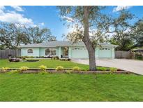 Charming home featuring a well-maintained lawn and a beautiful light green exterior at 611 Mobile Rd, Venice, FL 34293