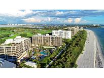 Aerial view of luxurious beachfront condos with pool and golf course at 535 Sanctuary Dr # A202, Longboat Key, FL 34228