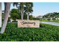 The Sanctuary community entrance sign, lush landscaping, and palm trees at 535 Sanctuary Dr # A202, Longboat Key, FL 34228