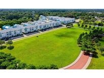 Aerial view of townhouses and a large green space at 2400 Ezzell Ct, Sarasota, FL 34237