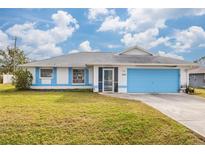 Inviting house with light blue accents and a well-maintained lawn at 1565 Piedmont Rd, Venice, FL 34293