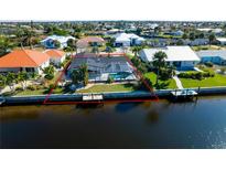 Aerial view of waterfront home with private pool and canal access at 1732 Boca Raton Ct, Punta Gorda, FL 33950