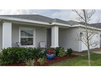 Inviting front porch with seating and landscaping at 16415 62Nd E Gln, Parrish, FL 34219