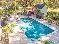 Inviting rectangular pool with surrounding patio and outdoor kitchen at 2910 49Th St, Sarasota, FL 34234