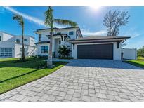 Two-story home with a modern design, two-car garage, and a paved driveway at 901 30Th E Ct, Bradenton, FL 34208