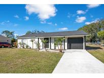 Newly renovated single-story home with driveway and landscaping at 7555 Hanchey St, North Port, FL 34287