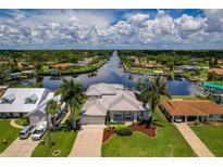 Aerial view of waterfront home with canal access and lush landscaping at 4440 Tatum St, Port Charlotte, FL 33948