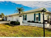 White single story home with attached garage and landscaped yard at 7315 8Th W Ave, Bradenton, FL 34209