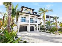 Two-story home with two-car garage and tropical landscaping at 551 S Washington Dr, Sarasota, FL 34236