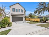 Two-story modern home with a two-car garage and landscaped front yard at 2554 Arlington St, Sarasota, FL 34239