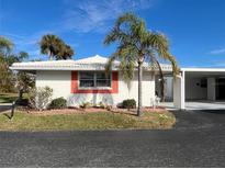 White single story home with carport and palm trees at 1741 Caribbean Cir # 13, Venice, FL 34293