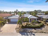 Single-Gathering home with a tile roof and landscaped yard at 322 Avenida De Paradisio, Sarasota, FL 34242
