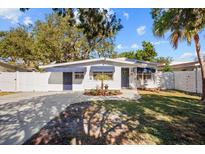 Charming white house with blue accents and a well-manicured lawn at 2369 Browning St, Sarasota, FL 34237