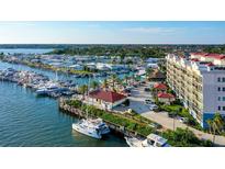 Gorgeous aerial view of the community marina with yachts, waterways, and clubhouse in this waterfront neighborhood at 505 Tamiami N Trl # 201, Venice, FL 34285