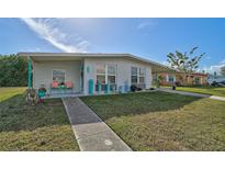 Charming ranch home with a landscaped lawn and walkway at 740 Floral Ln, Port Charlotte, FL 33952