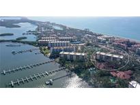 Stunning aerial view of the condos with beach and water access, boat docks, and waterfront condos at 8625 Midnight Pass Rd # 505B, Sarasota, FL 34242