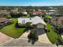 Aerial view of a single-Gathering home with a large yard and paved driveway at 219 Keel Way, Osprey, FL 34229