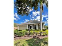 Charming single-story home with a well-manicured front yard and a classic architectural style at 8332 Karpeal Dr, Sarasota, FL 34238