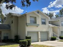 Two-story condo with attached garage and lush landscaping at 5405 Fair Oaks St # 5405, Bradenton, FL 34203