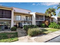 Two-story condo building with balconies, landscaping, and parking at 5420 Swift Rd # 38, Sarasota, FL 34231