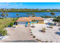 Aerial view of waterfront home with dock and landscaped yard at 725 N Manasota Key Rd # A, Englewood, FL 34223