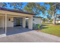 Condo exterior featuring carport and landscaped lawn at 6100 Green View Dr # 145, Sarasota, FL 34231