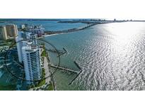 Aerial view of waterfront highrise building with parking and marina at 988 Blvd Of The Arts # 915, Sarasota, FL 34236