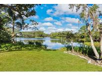 Scenic lakefront property with lush green lawn at 3512 E Forest Lake Dr, Sarasota, FL 34232