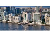 Aerial view of a luxury highrise building on the waterfront at 258 Golden Gate Pt # 801, Sarasota, FL 34236