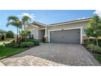 Single-story home with a two-car garage and nicely landscaped front yard at 5433 Hope Sound Cir, Sarasota, FL 34238