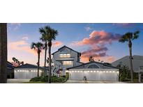 Two-story waterfront home with attached garage and palm trees at 1325 Siesta Bayside Dr # 1325B, Sarasota, FL 34242