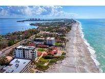 Aerial view of beachfront property, showcasing oceanfront building and beach at 4241 Gulf Of Mexico Dr # 202, Longboat Key, FL 34228