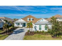 White two-story house with gray roof and paved driveway at 16511 Cornwall Ln, Bradenton, FL 34202