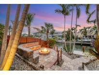Waterfront fire pit with seating, offering tranquil views at 1739 Shelburne Ln, Sarasota, FL 34231