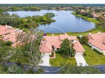 Aerial view of villa with lake access and lush landscaping at 7323 Oak Moss Dr # 42, Sarasota, FL 34241
