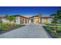 Stunning curb appeal with a modern design, landscaped grounds, and a paved driveway at 1206 Blue Shell Loop, Sarasota, FL 34240