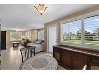 Bright living room with neutral tones, plantation shutters, and tile flooring, offering a cozy and inviting atmosphere at 1348 Westport Ln # 1405, Sarasota, FL 34232