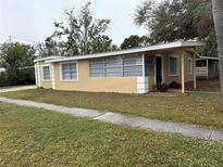 Ranch-style home with a large window and attached garage at 1630 29Th St, Sarasota, FL 34234