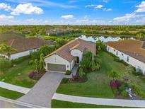 Aerial view of a single-Gathering home with a lake view in a residential community at 217 Malina Ct, Nokomis, FL 34275