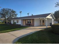 Ranch-style home with carport and mature landscaping at 4514 103Rd W St, Bradenton, FL 34210