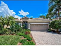 Attractive single-story home with a gray exterior, tile roof, and landscaped front yard at 293 Turquoise Ln, Osprey, FL 34229