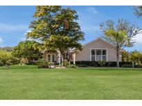Single-story home with a manicured lawn and lush landscaping at 8022 Snowy Egret Pl, Lakewood Ranch, FL 34202